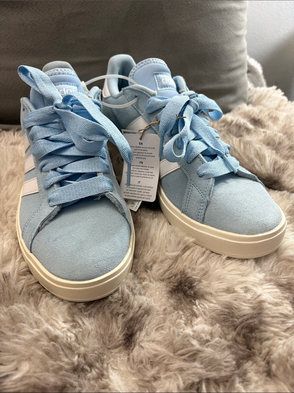 adidas Women's Sky Blue Suede Low-Top Sneakers with White Stripes.